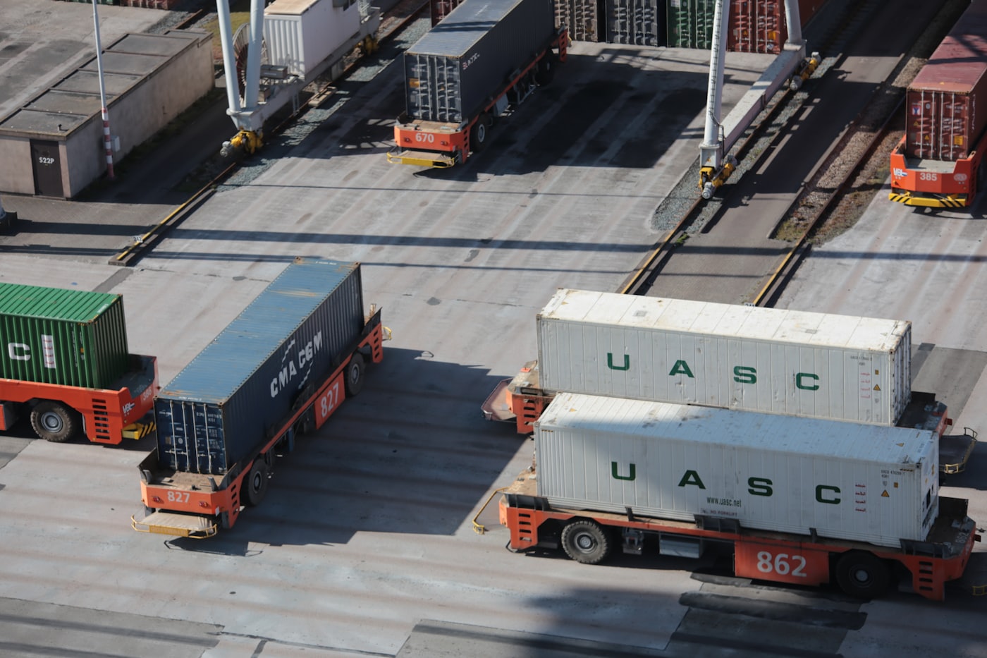 Container handlers moving containers at a port terminal